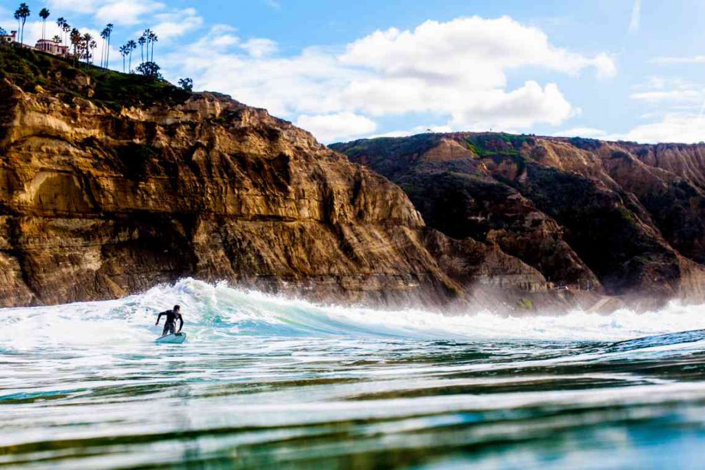 A man surfing off the coast of San Diego.