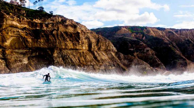 A man surfing off the coast of San Diego