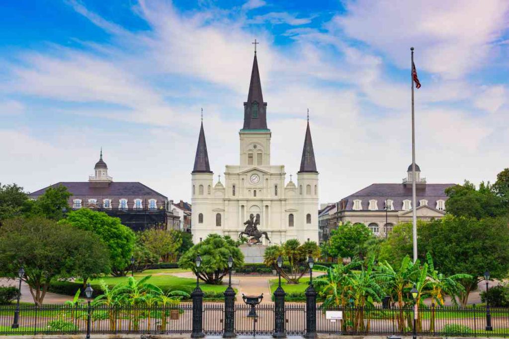 White exterior of St. Louis Cathedral and Jackson Park in New Orleans.