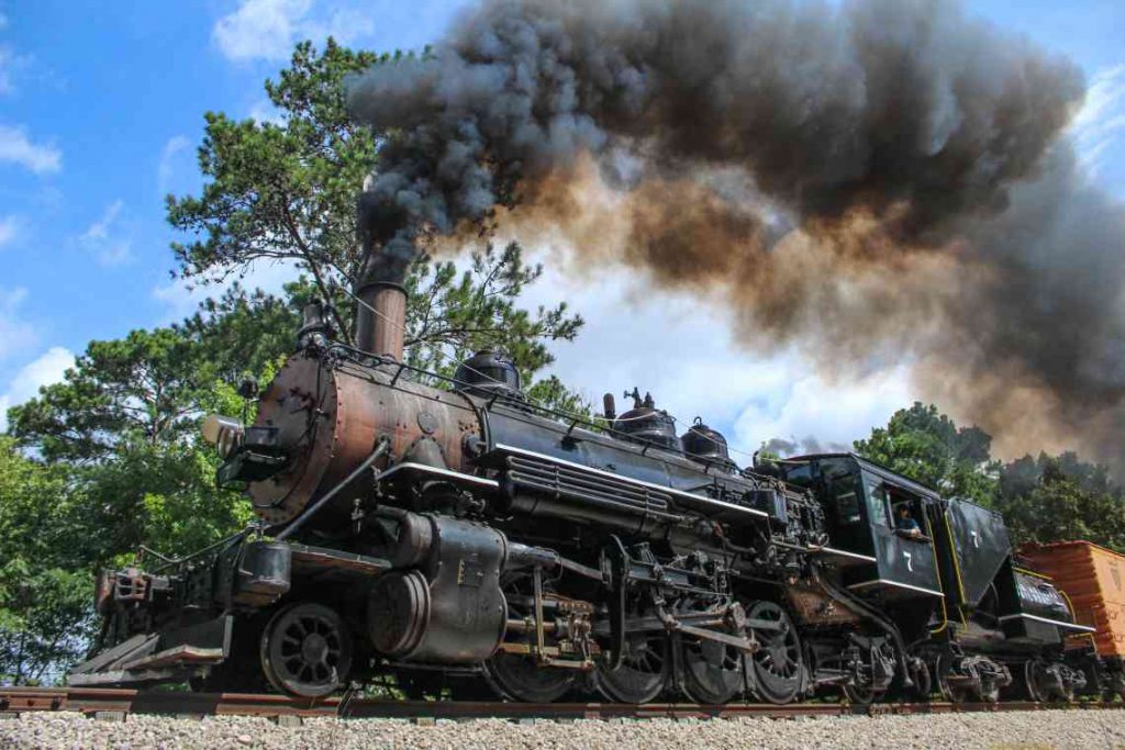 Old fashioned Texas State Railroad locomotive with plume of smoke
