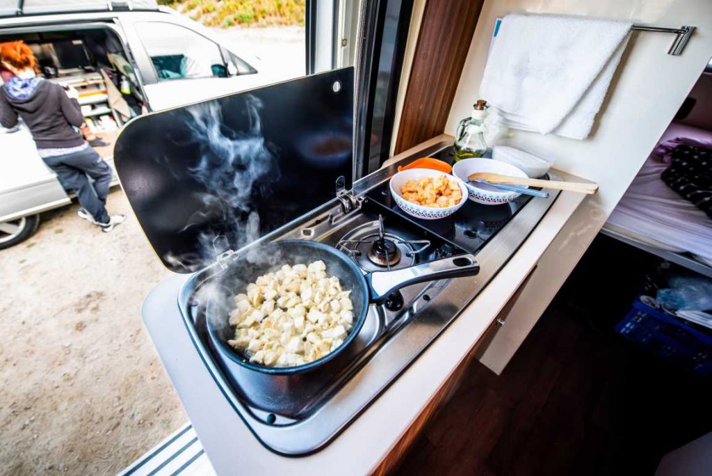 Pans with food cooking in a camper