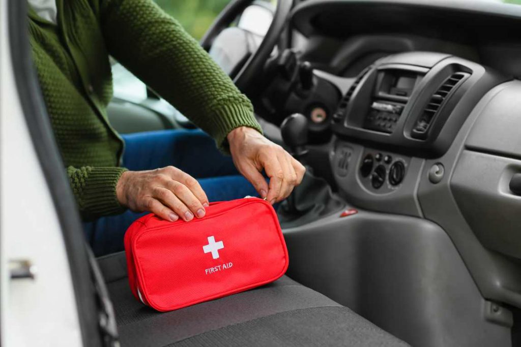 Red first aid kit sitting on car seat