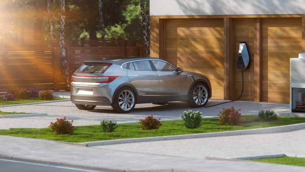 Electric SUV plugged into charger in front of a home