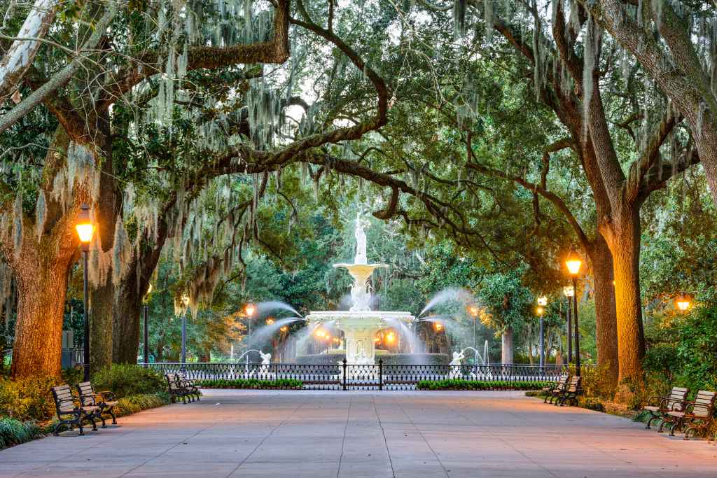 Moss draped trees in front of a fountain in Forsyth Park in Savannah, GA.