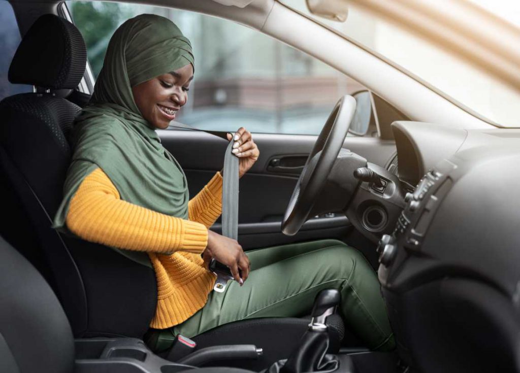 Woman in hijab buckling her seat belt