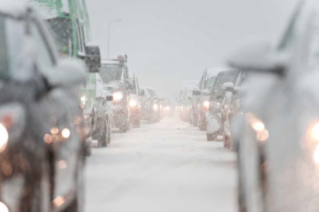 Snow covered cars in a traffic jam