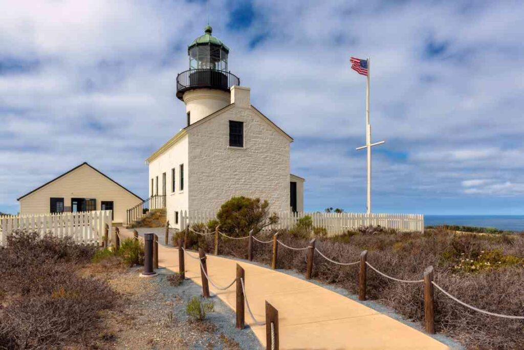 Walkway leading to a white lighthouse on a hill