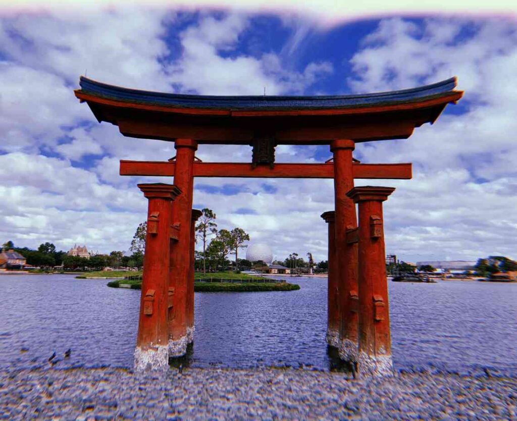 red japanese pavillion sitting on the water