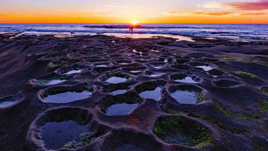 Tide pools on the beach at sunset