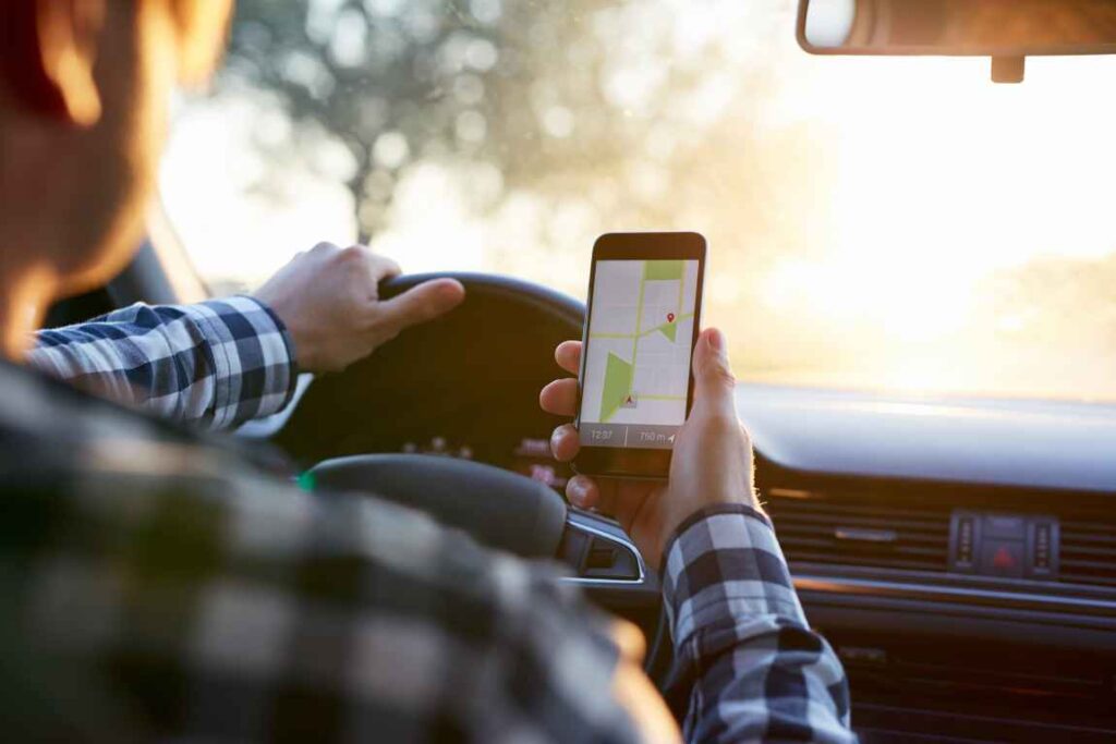 Person holding phone with mapping app on the screen