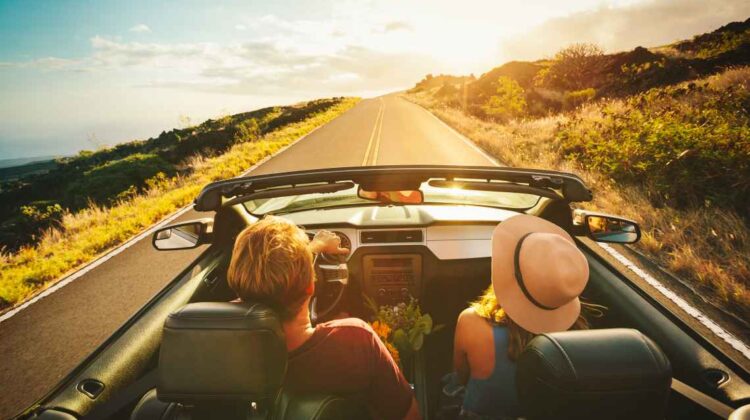 man and woman in a convertible on a sunny day