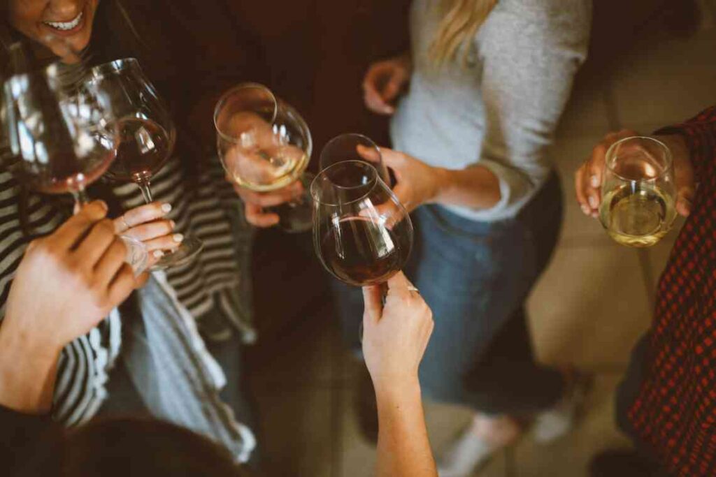 People clinking wine glasses