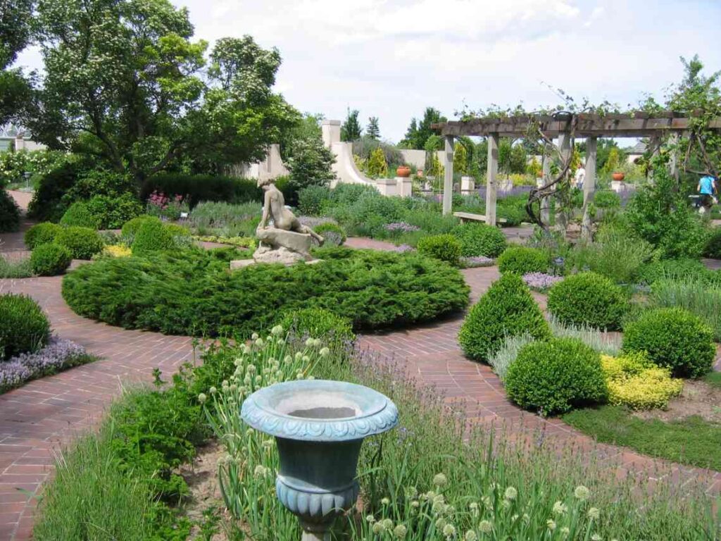 manicured gardens with walkways and statues