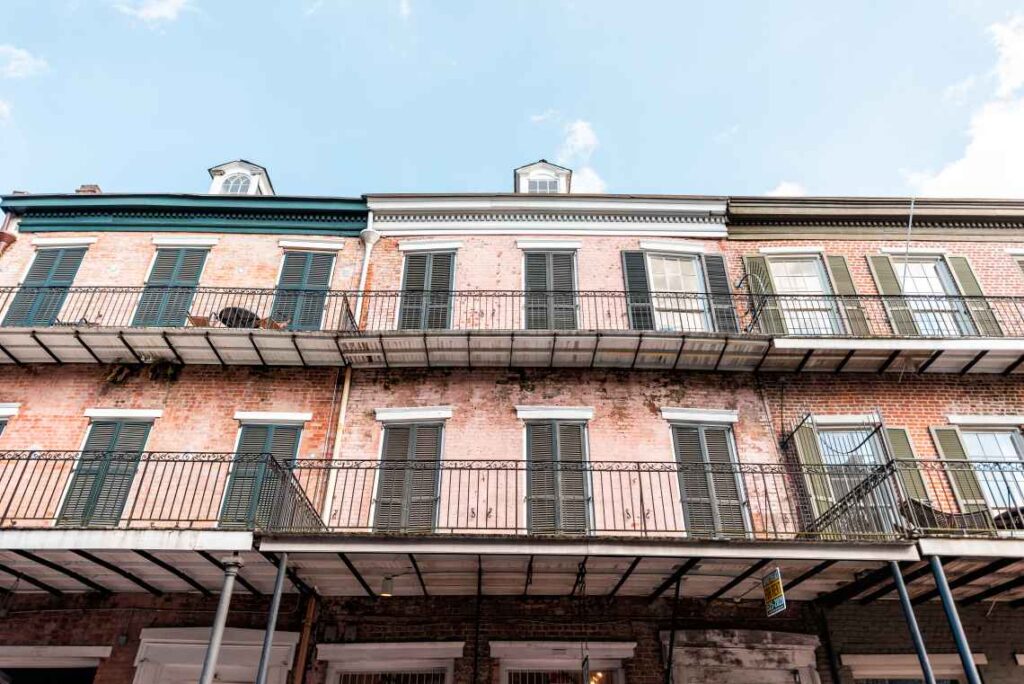 brick buildings with dark shutters and black balconies