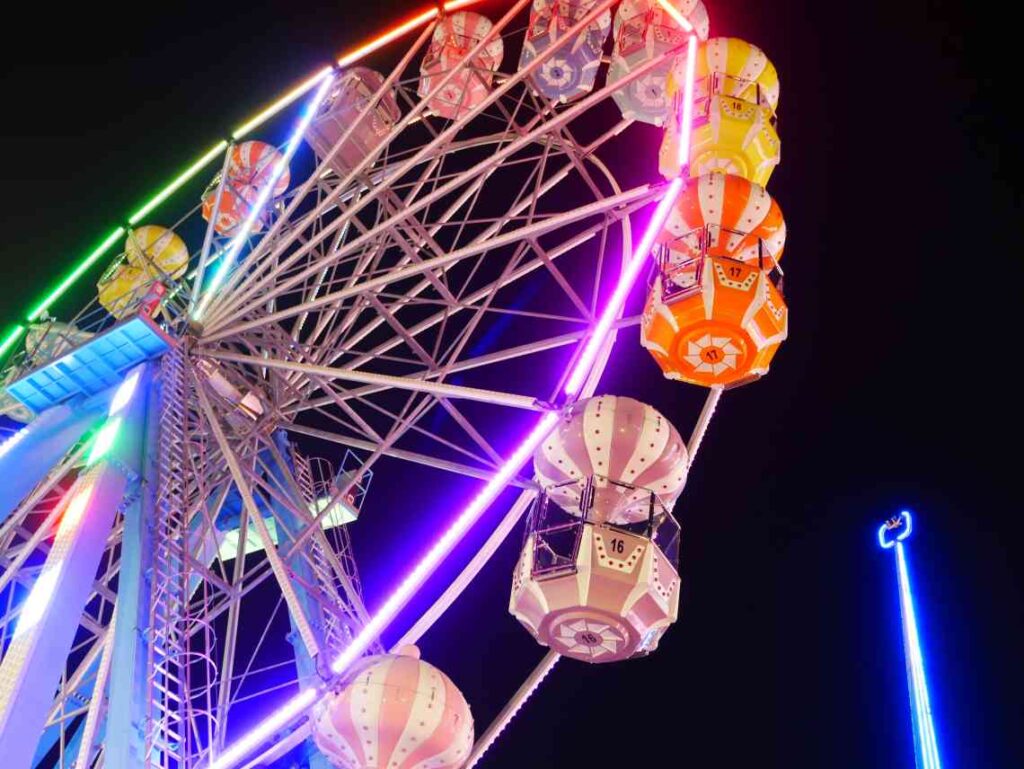 Old fashioned Ferris Wheel lit up at night