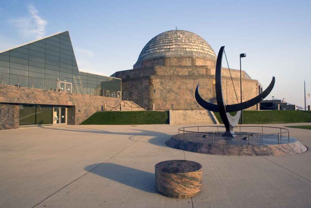 exterior of adler planetarium with metal sculpture