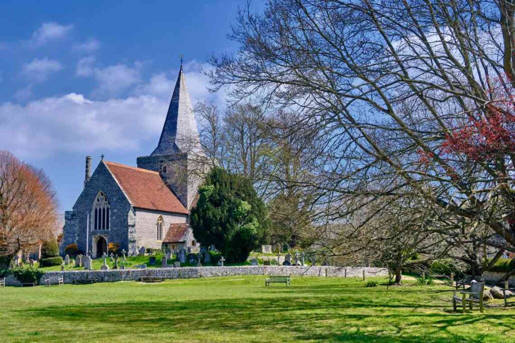 old stone st. Andrews Church and graveyard surrounded by green lawn