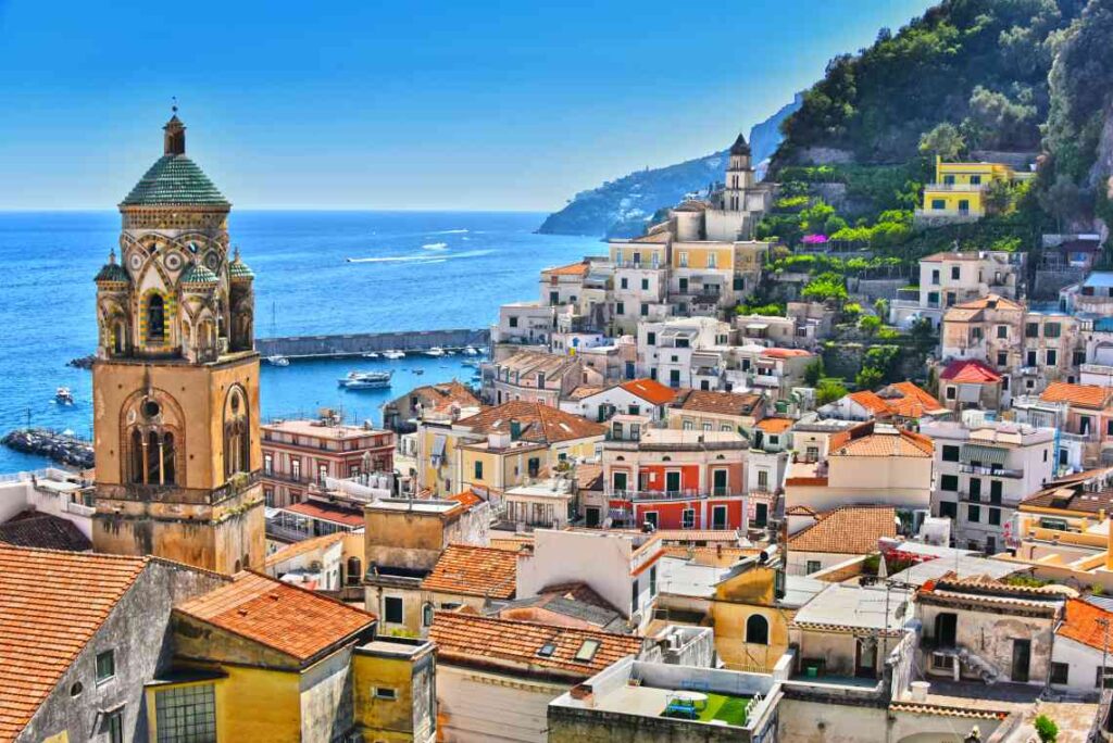 colorful houses and church tower overlooking the sea