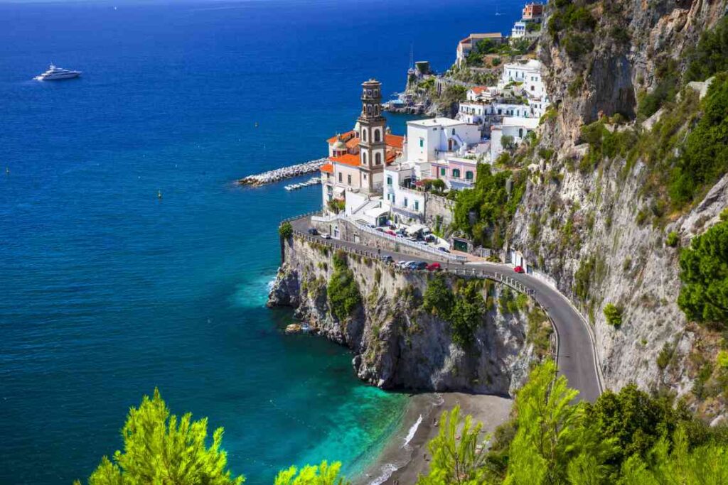 road going into small town of atrani, amid rocks on the ocean