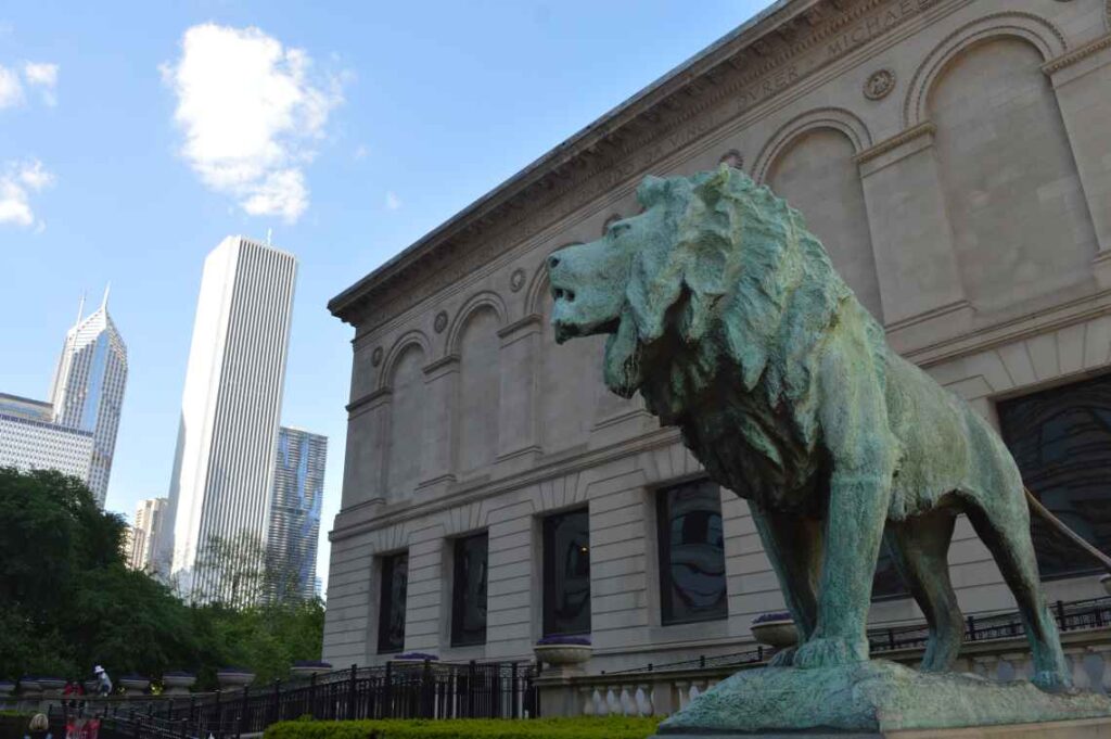 Bronze lion statue with Chicago skyscrapers in the background