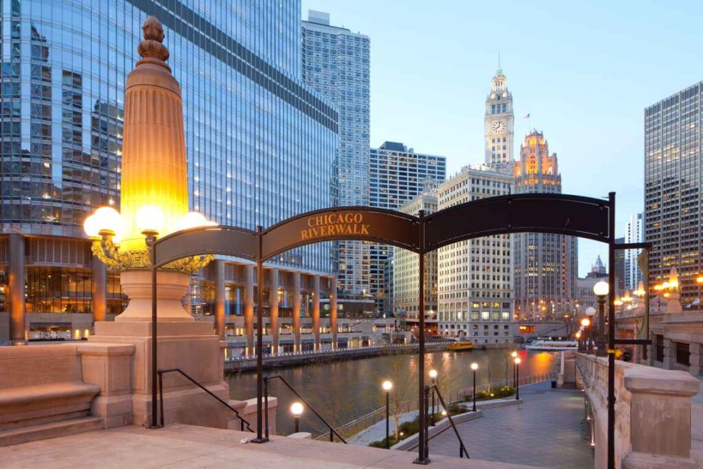 entrance to chicago riverwalk with skyscrapers in the background
