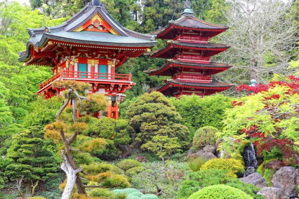 colorful pagodas and sculpted trees and bushes in a park