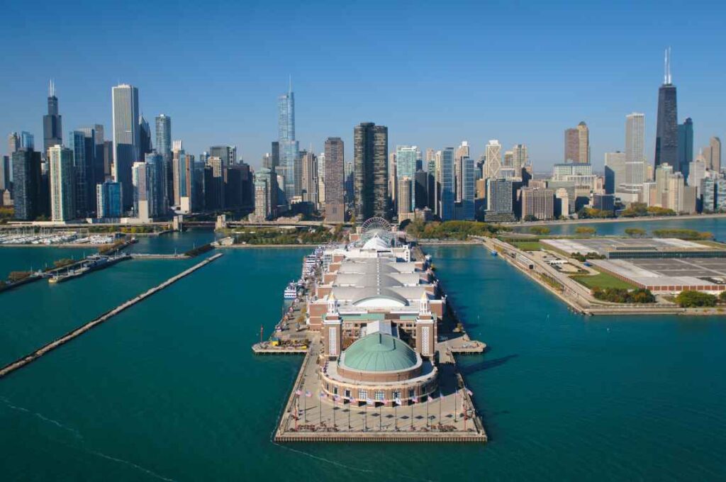 navy pier jutting into lake michigan with chicago skyline in the background