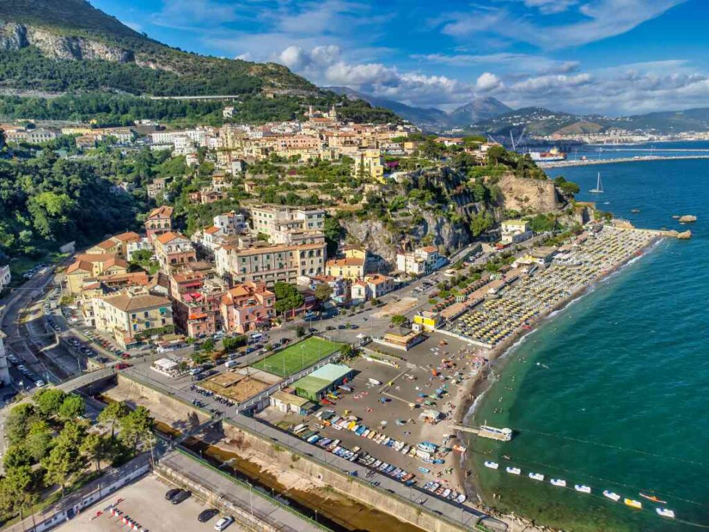 Large beach with town on the hillside above it