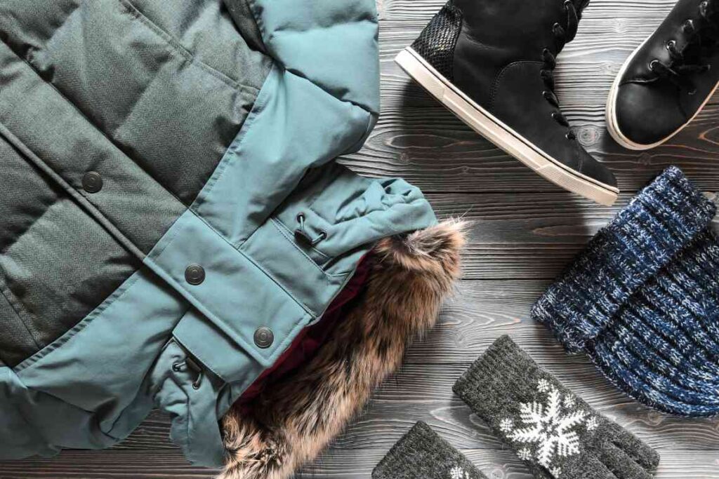 winter parka, gloves hat and boots laid out