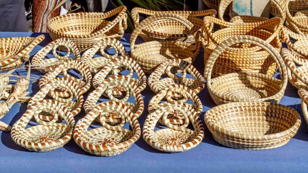 brown woven baskets made from sweetgrass sitting on a blue table at the charleston city market