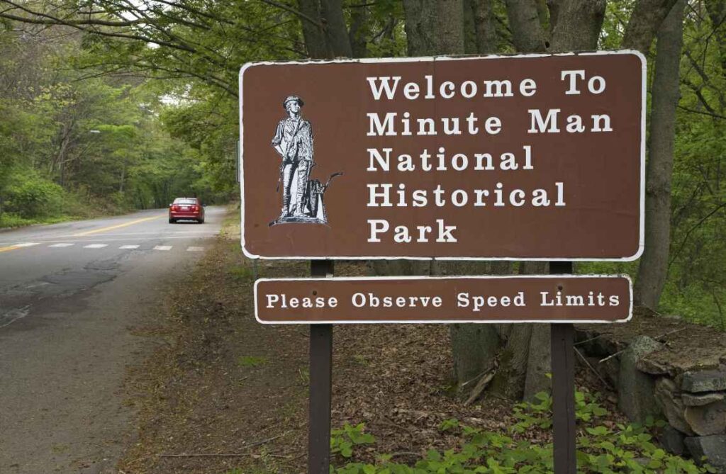 Brown sign saying Welcome to Minute Man National Historical Park, Please Observe Speed Limits