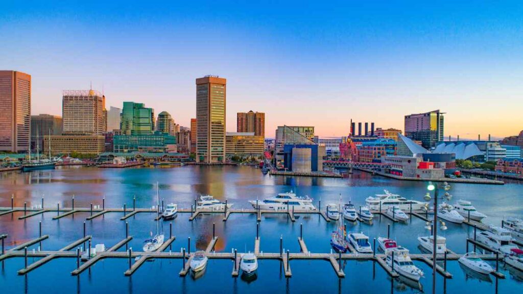boats in the inner harbor of baltimore with skyline and buildings in the background