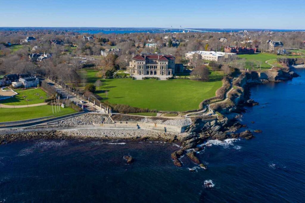 The Breakers estate in Newport Rhode Island from above, with the ocean in front of it.