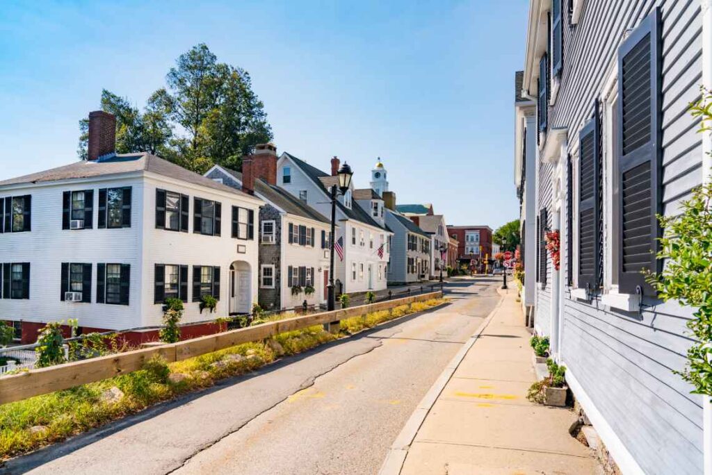 historic houses with black shutters and chimneys on a street in plymouth massachusetts