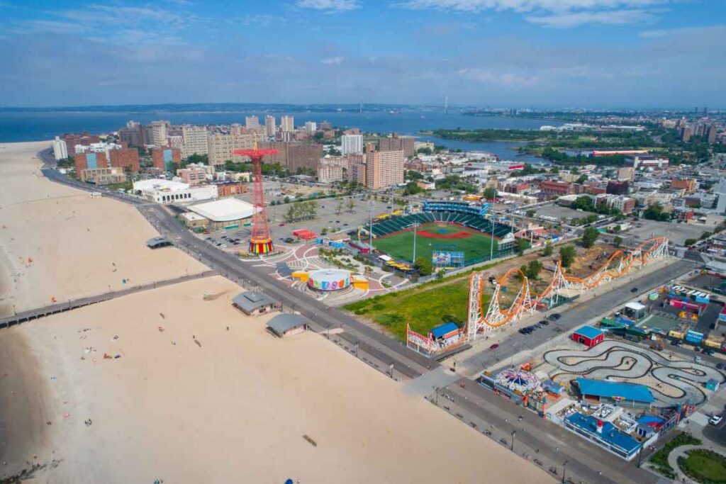 beach, boardwalk and amusement park of coney island from above