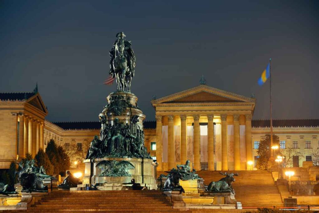 statues in front of philadelphia museum of art entrance at night