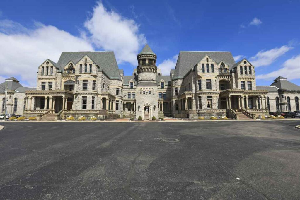 stone exterior of ohio state reformatory taken from the black asphalt parking lot