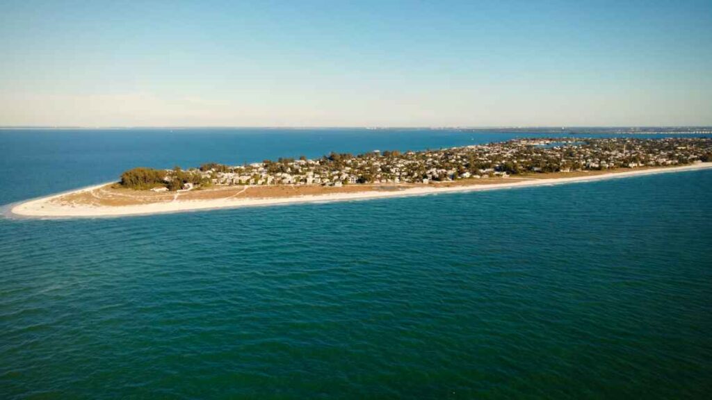 long thin island from above with a beach on the outer edge and houses inside