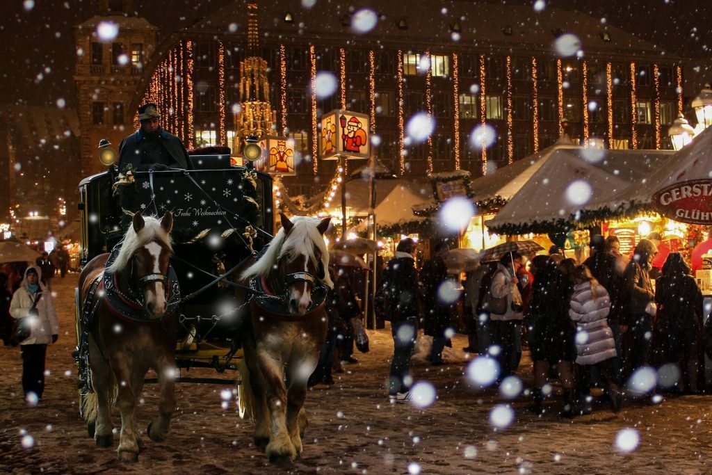 snowy christmas market in nuremberg germany with horse drawn carriage