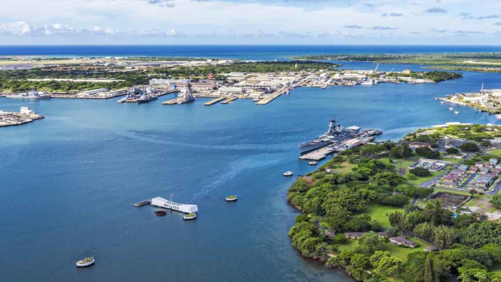 aerial shot of uss arizona and uss missouri battleships on the water at the pearl harbor national memorial