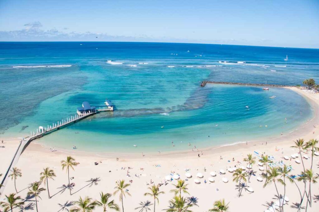 horseshoe shaped waikiki beach with white sand and turquoise water on the island of oahu in hawaii