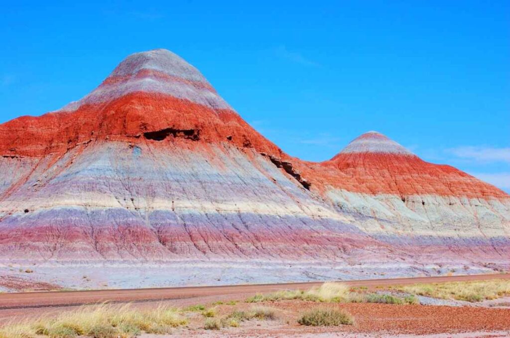 bands of purple and red color on rock formations in the painted desert of arizona