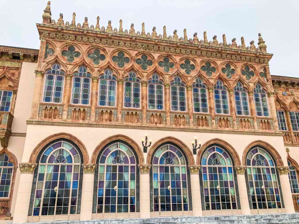 pink ornate exterior of the john and mable ringling museum of art on sarasota by in florida with stained glass windows