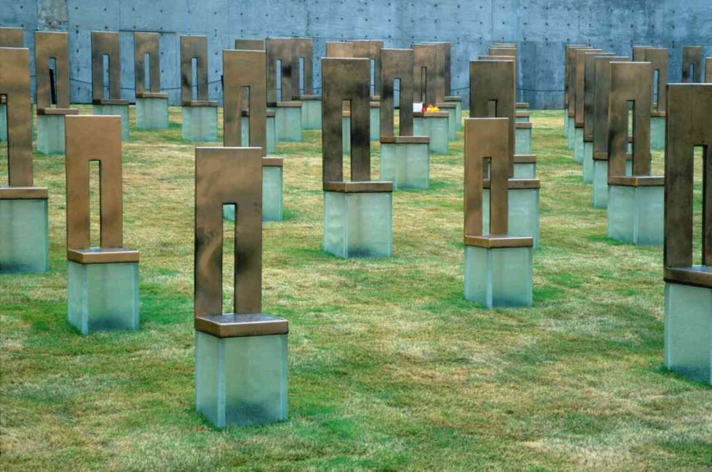 metal and glass monuments sitting in grass as part of the oklahoma city bombing memorial
