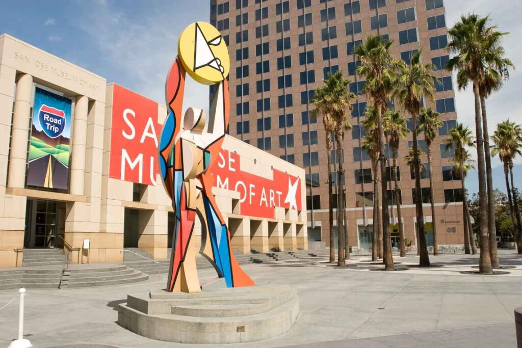 front of san jose museum of art with large piece of multicolored artwork in front