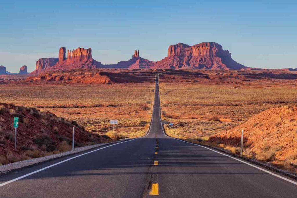 section of us 163 in utah with red rock formations and red rock desert