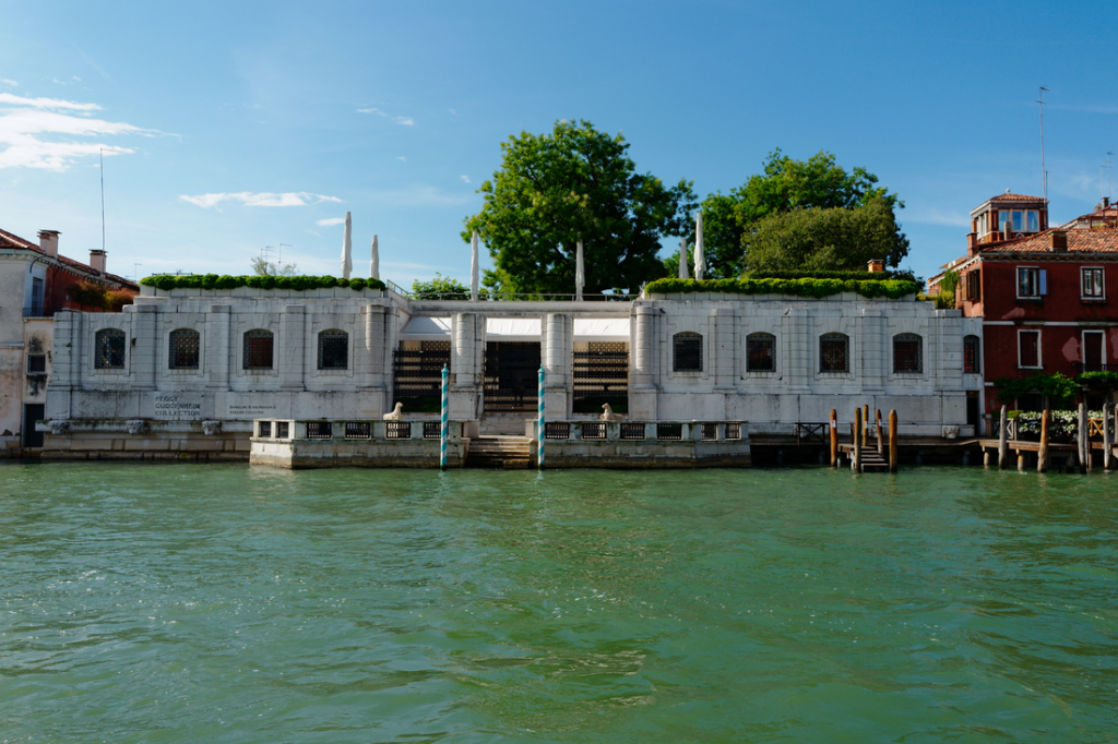 exterior of the white stone peggy guggenheim collection building in venice from the water