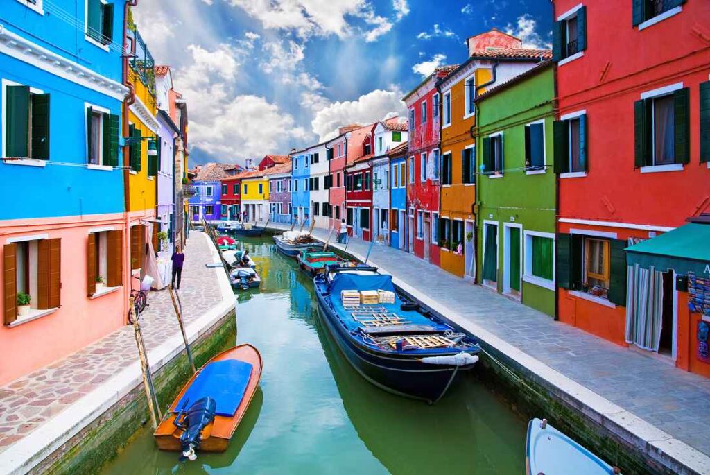 colorful houses along a canal with boats