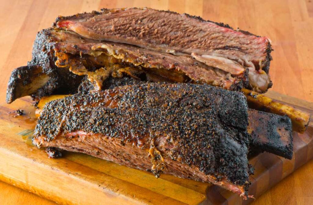 close up of spiced beef ribs on a cutting board