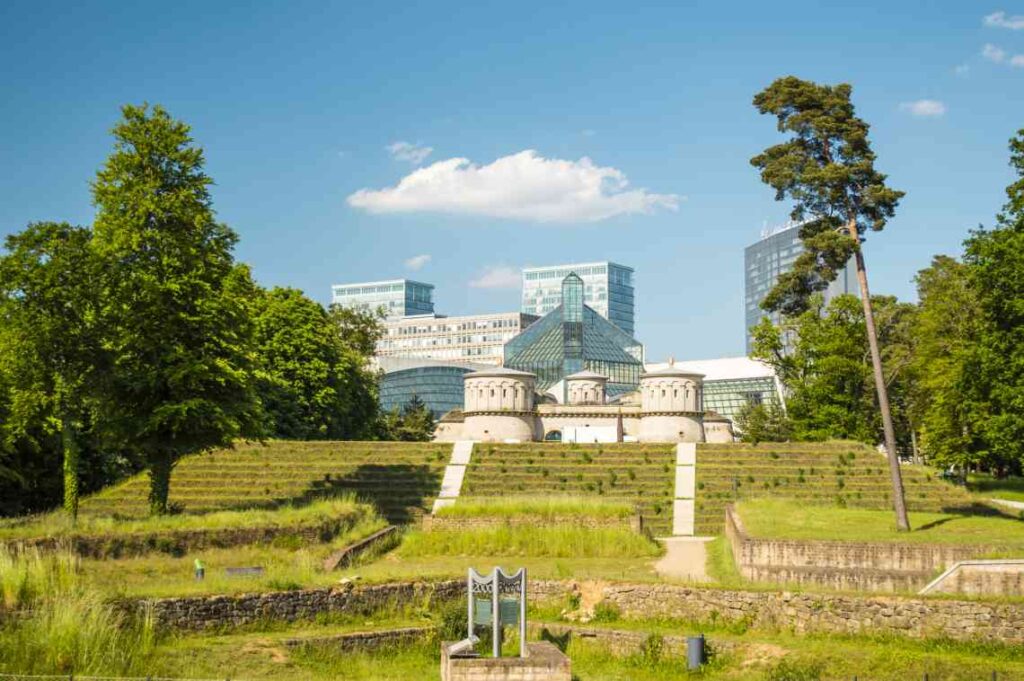 grounds of grand duke jean museum of modern art in luxembourg, with the exterior of the building in the background on a sunny day